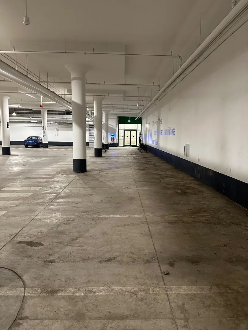 Dusty and stained underground parking area before pressure cleaning